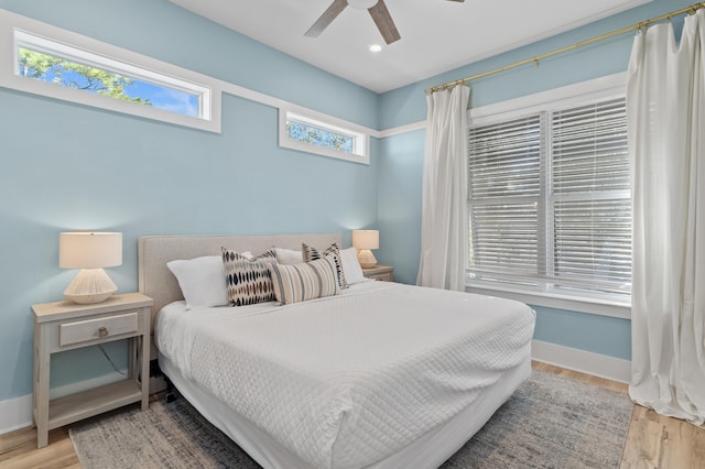 bedroom with a ceiling fan, baseboards, wood finished floors, and recessed lighting