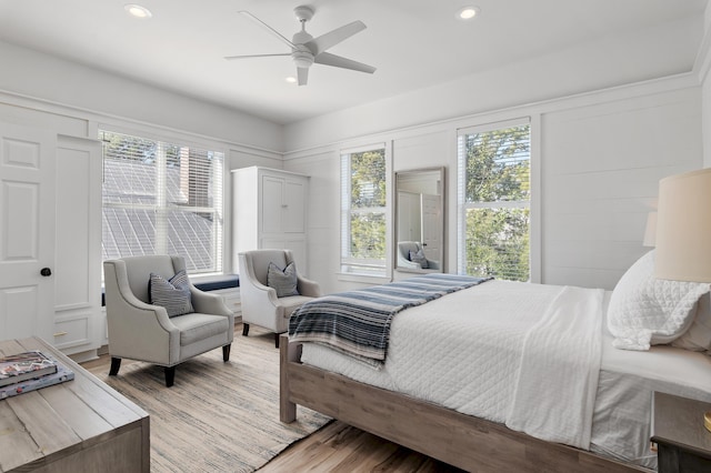 bedroom featuring light wood finished floors, a ceiling fan, and recessed lighting