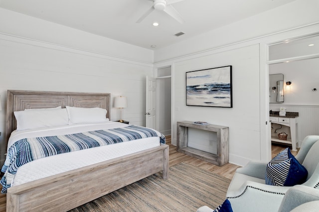 bedroom featuring ceiling fan, light wood-type flooring, and visible vents