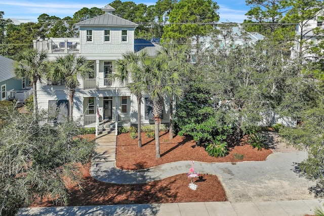 view of front of home with a porch and a balcony