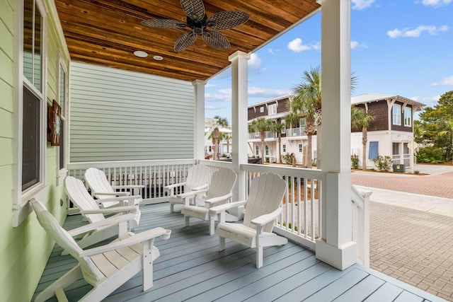 wooden terrace featuring a ceiling fan and a residential view