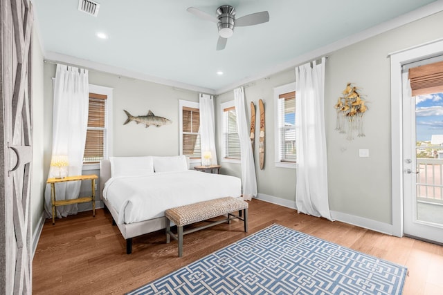 bedroom with ceiling fan, wood finished floors, visible vents, baseboards, and access to outside