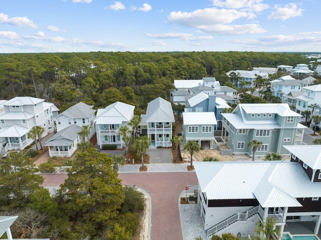 drone / aerial view with a residential view and a wooded view