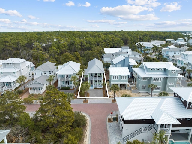 birds eye view of property with a residential view and a wooded view