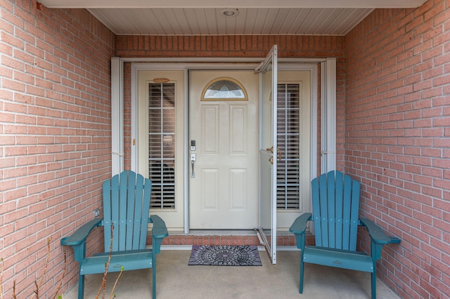 doorway to property with brick siding