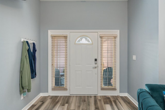 entrance foyer with baseboards and wood finished floors