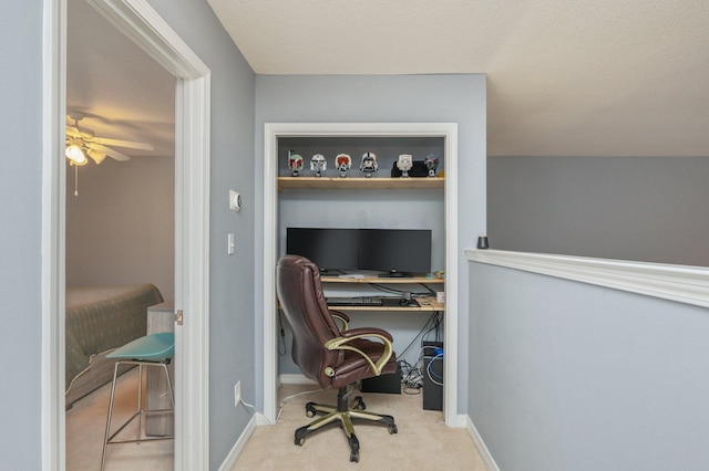 office space with light carpet, ceiling fan, and baseboards