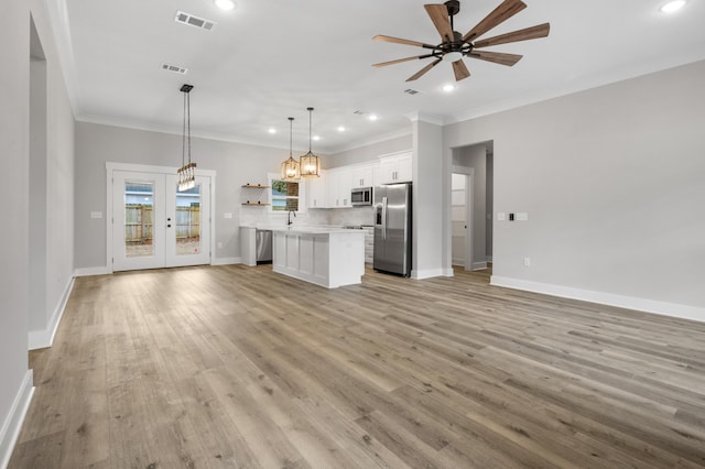 kitchen featuring appliances with stainless steel finishes, open floor plan, visible vents, and open shelves