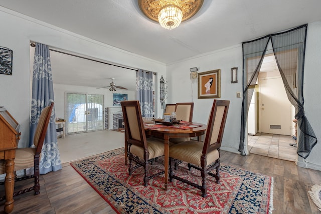 1005 Revere Dr, Pensacola, FL 32506 - dining room featuring wood finished floors, ceiling fan with notable chandelier, and visible vents
