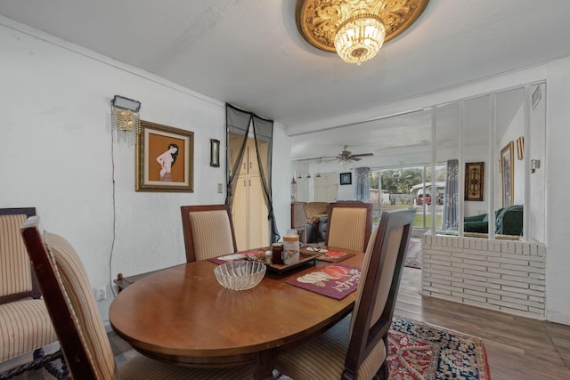 1005 Revere Dr, Pensacola, FL 32506 - dining space featuring ceiling fan with notable chandelier and wood finished floors
