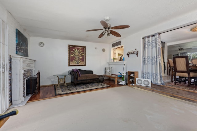 1005 Revere Dr, Pensacola, FL 32506 - living area featuring a ceiling fan, concrete flooring, and a fireplace