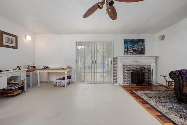 1005 Revere Dr, Pensacola, FL 32506 - living area with a stone fireplace, finished concrete floors, and ceiling fan