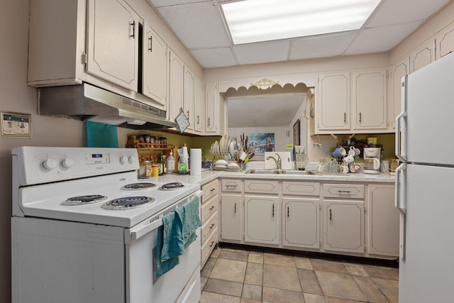 1005 Revere Dr, Pensacola, FL 32506 - kitchen with light countertops, white appliances, under cabinet range hood, a sink, and a drop ceiling