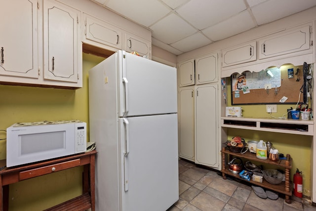 1005 Revere Dr, Pensacola, FL 32506 - kitchen with white appliances, white cabinets, and a drop ceiling