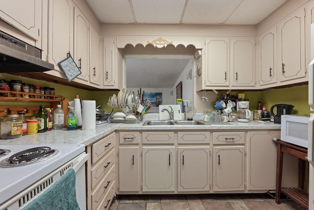 1005 Revere Dr, Pensacola, FL 32506 - kitchen with light countertops, a sink, white appliances, white cabinets, and a drop ceiling