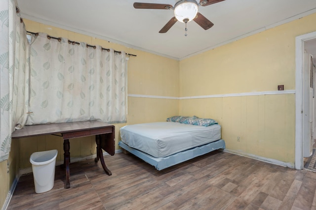 1005 Revere Dr, Pensacola, FL 32506 - bedroom featuring a wainscoted wall, wood finished floors, and a ceiling fan