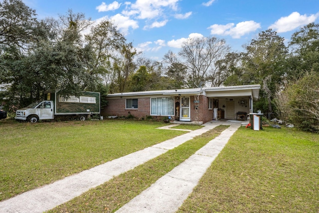 1005 Revere Dr, Pensacola, FL 32506 - view of front facade featuring brick siding, a front yard, driveway, and a carport