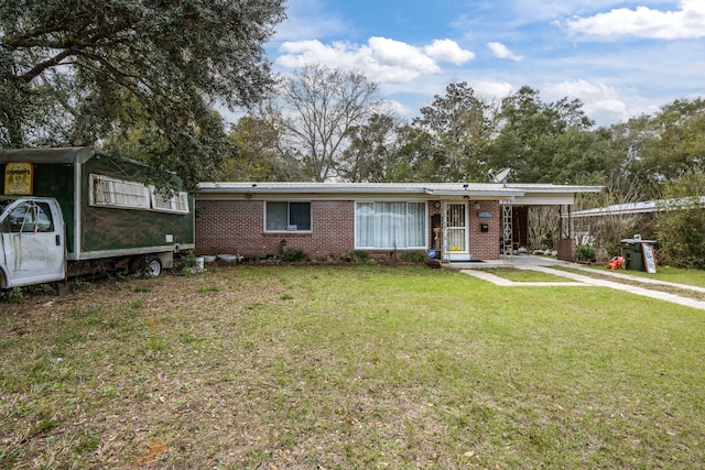 1005 Revere Dr, Pensacola, FL 32506 - view of front of home featuring a front yard, brick siding, an attached carport, and driveway