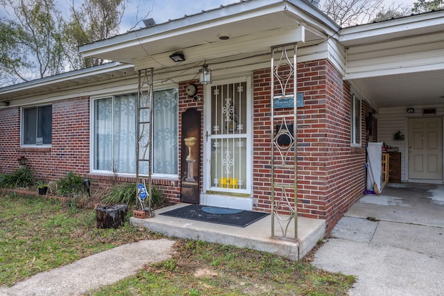 1005 Revere Dr, Pensacola, FL 32506 - property entrance with driveway, brick siding, and an attached carport