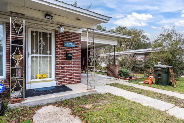 1005 Revere Dr, Pensacola, FL 32506 - entrance to property with driveway, an attached carport, and brick siding