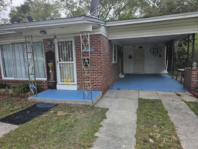 1005 Revere Dr, Pensacola, FL 32506 - exterior space with brick siding, driveway, and a carport