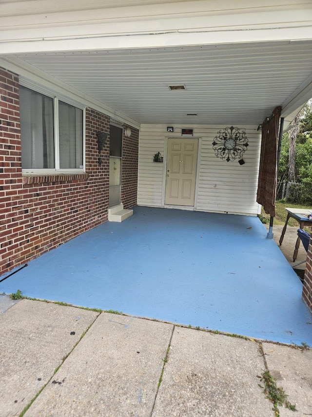 1005 Revere Dr, Pensacola, FL 32506 - view of patio featuring an attached carport and driveway
