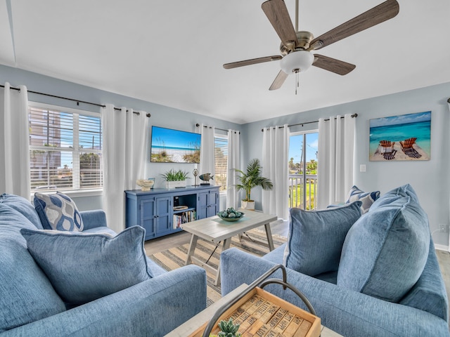 living room featuring a ceiling fan and light wood-style flooring