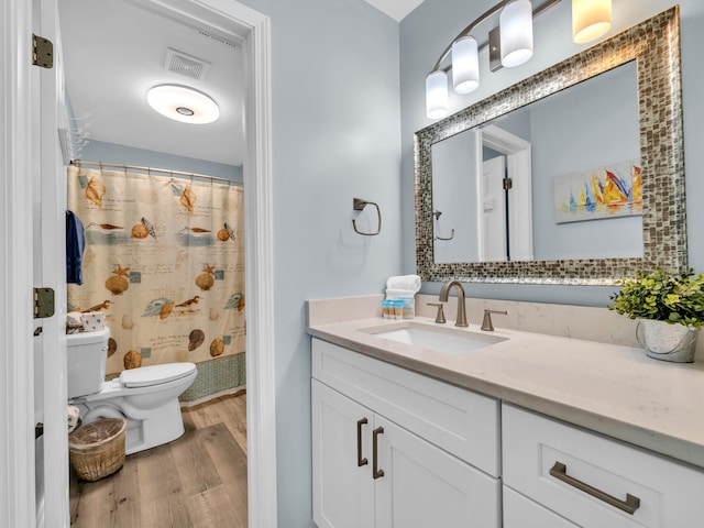 full bathroom with visible vents, toilet, vanity, wood finished floors, and a shower with curtain