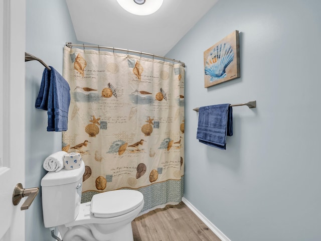 full bath with curtained shower, baseboards, toilet, and wood finished floors