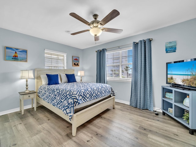 bedroom with wood finished floors, a ceiling fan, and baseboards