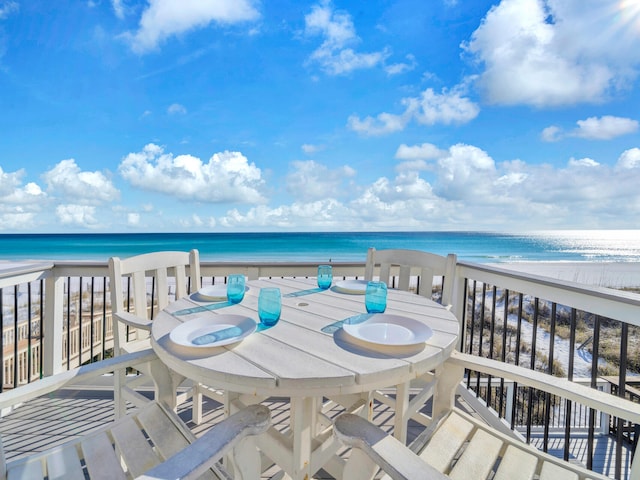 balcony featuring a water view and a beach view