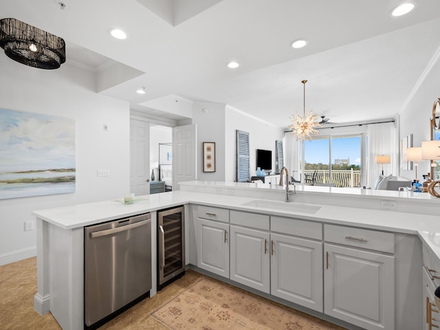 kitchen featuring wine cooler, ornamental molding, an inviting chandelier, stainless steel dishwasher, and a sink