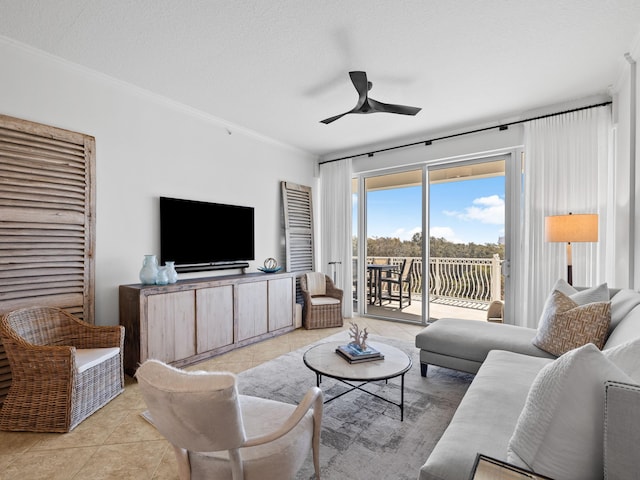 living room featuring light tile patterned floors, ceiling fan, a textured ceiling, and crown molding