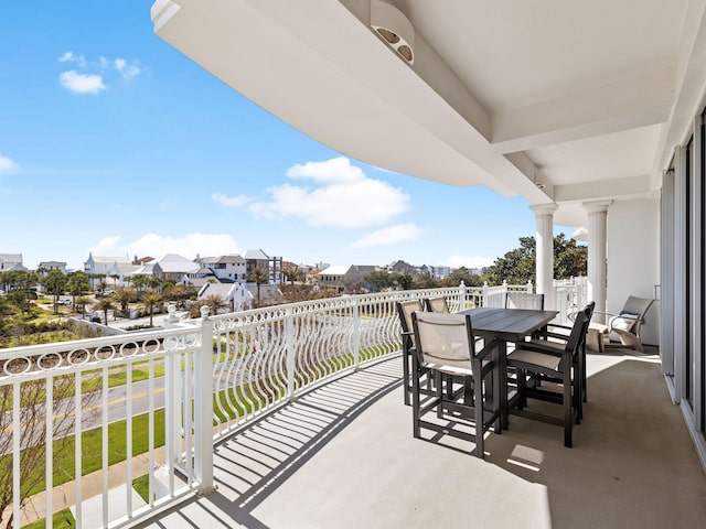 balcony with outdoor dining area and a residential view