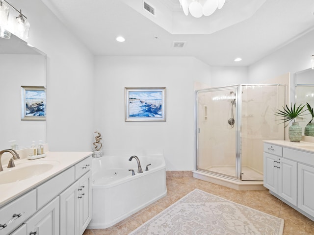 bathroom featuring visible vents, a sink, tile patterned flooring, a shower stall, and two vanities