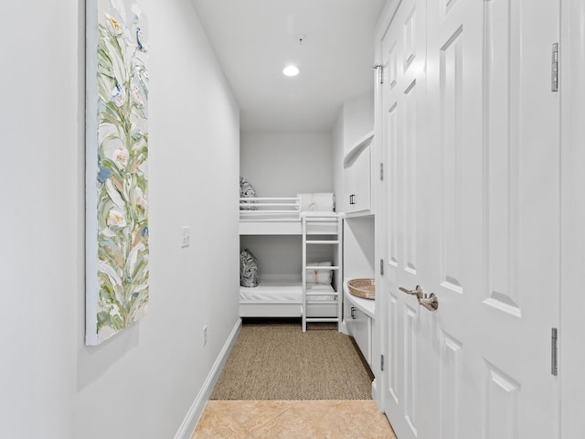 bedroom with light tile patterned floors, baseboards, light colored carpet, and recessed lighting