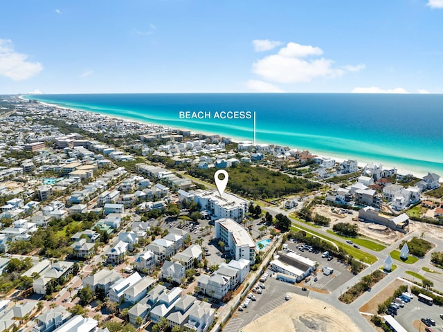 drone / aerial view with a beach view, a water view, and a residential view