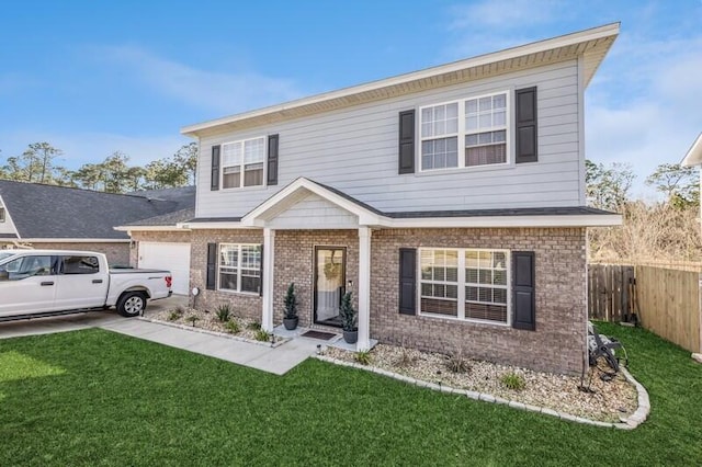 view of front facade featuring a front yard, fence, and brick siding