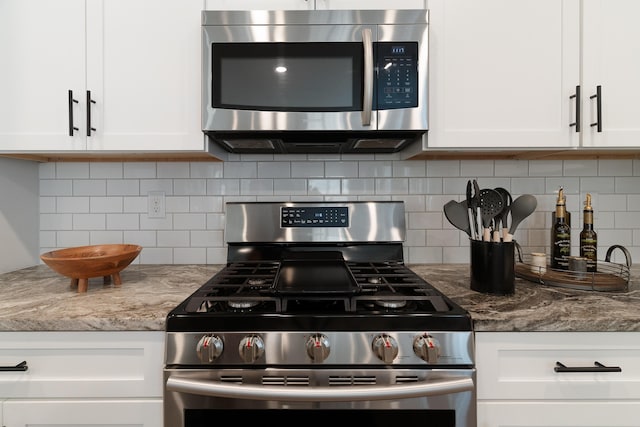 kitchen with light stone countertops, tasteful backsplash, white cabinetry, and stainless steel appliances