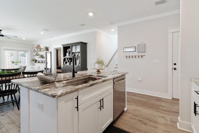 kitchen with a kitchen island with sink, a sink, white cabinets, light stone countertops, and dishwasher