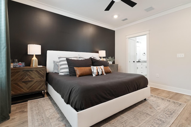 bedroom featuring baseboards, crown molding, visible vents, and light wood-style floors