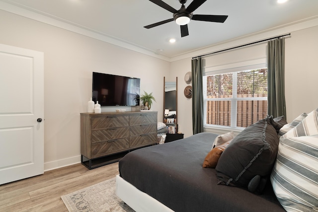 bedroom with light wood-style flooring, recessed lighting, a ceiling fan, baseboards, and crown molding