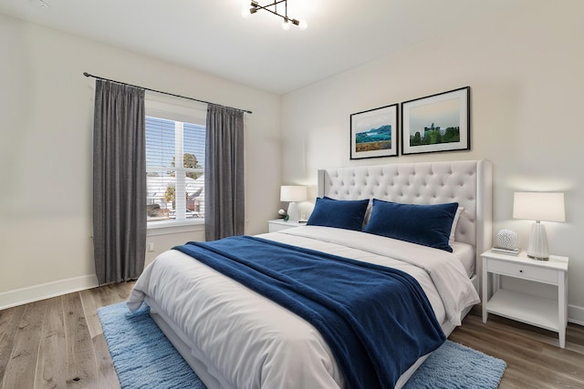 bedroom featuring wood finished floors and baseboards