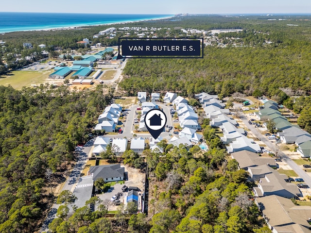 aerial view with a residential view, a water view, and a view of trees