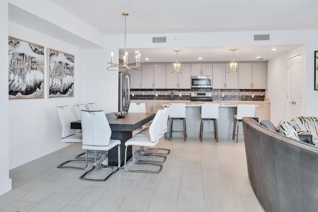 dining room featuring recessed lighting, visible vents, a notable chandelier, and baseboards