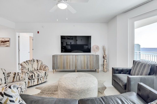 living area featuring a ceiling fan