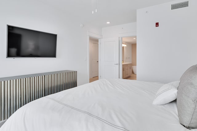 bedroom with recessed lighting, visible vents, and ensuite bath