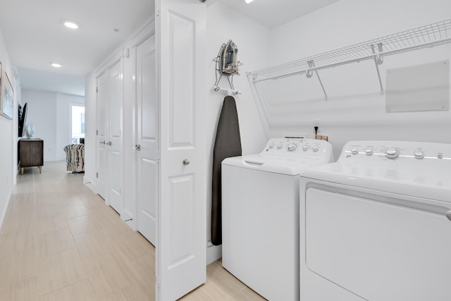 clothes washing area featuring washer and dryer and laundry area