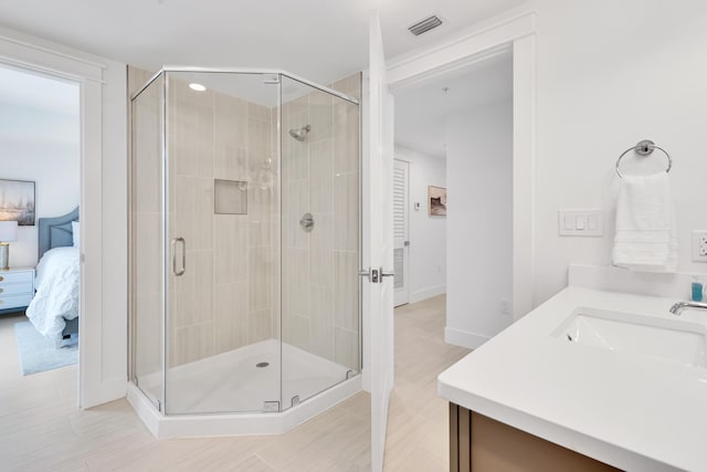 bathroom featuring visible vents, a shower stall, vanity, and ensuite bathroom