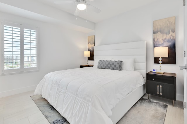 bedroom with ceiling fan and baseboards